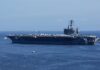 Trump Signals Iran De-Escalation as Markets Rise A large aircraft carrier sailing in the ocean