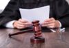 Explosive Allegations Rock Maine Senate Race A judge holding documents with a gavel in the foreground