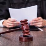 Explosive Allegations Rock Maine Senate Race A judge holding documents with a gavel in the foreground