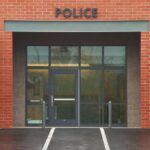 Caught on Camera: Driver Accused of Running Down Pedestrians Entrance of a modern police station with brick facade