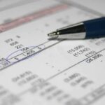 Trillion Hype, Zero Numbers Close-up of a financial document with highlighted numbers and a pen