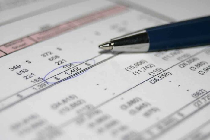 shutterstock_954645-1 Close-up of a financial document with highlighted numbers and a pen