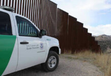 Rideshare Trap: One Ride Request Could End in Arrest Border protection vehicle near a large metal fence.