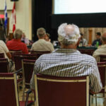 People attending a meeting in a conference room.