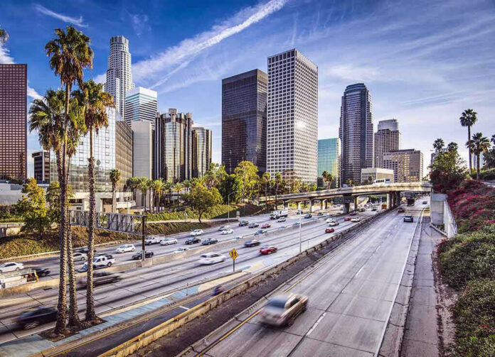 172033643 Downtown cityscape with skyscrapers and highway traffic.