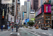 Record Heat Dome Puts Nearly Half of U.S. at Risk Times Square street scene with storefronts and advertisements.