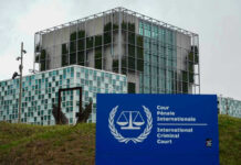 EU Builds Offshore: The Church Is Sounding the Alarm International Criminal Court building with sign in foreground.