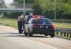 Trump Shuts Down ICE Traffic Stop Pause After Conservative Backlash Police officer conducting a traffic stop on a highway