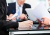 Crime, Deportation: The Debate Over What News Stories Should Say Close-up of a hand writing notes during a business meeting
