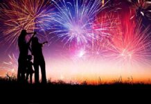 America’s Largest Fireworks Show Came With a Major Twist Silhouetted figures watching a colorful fireworks display against a twilight sky