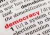 Intelligence Disputes Vote-Tampering Narrative Close-up of a dictionary page defining the word democracy