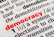Intelligence Disputes Vote-Tampering Narrative Close-up of a dictionary page defining the word democracy