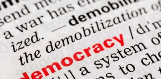 Close-up of a dictionary page defining the word democracy