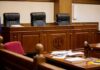 Federal Court Says Public Interest empty courtroom with judge's bench and microphones