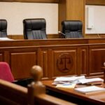 empty courtroom with judge's bench and microphones