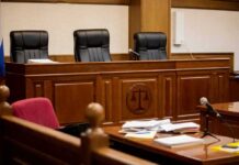 empty courtroom with judge's bench and microphones