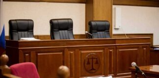 empty courtroom with judge's bench and microphones