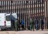 New Border Crackdown Targets Illegal Reentry Border agents escort a group near a tall fence and a patrol van