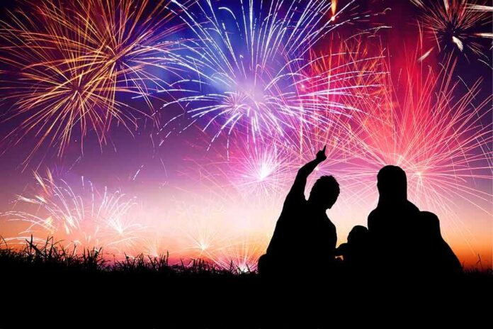 shutterstock_214325266 Silhouetted figures enjoying a fireworks display against a colorful night sky