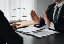 Businessman refusing an envelope at a desk