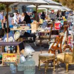90% Gone in Days: Turkish Carpet Seller Reveals A bustling flea market with various antique items and furniture for sale