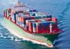 White House Hormuz Plan Hits a Legal Wall A large cargo ship loaded with colorful containers sailing on the ocean