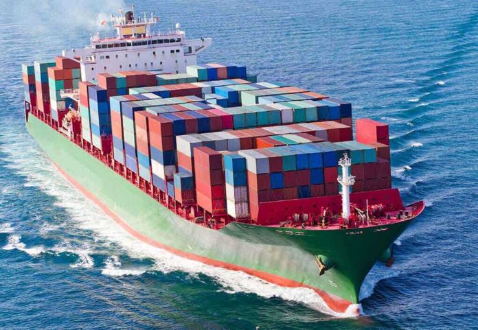 shutterstock_230506738 A large cargo ship loaded with colorful containers sailing on the ocean