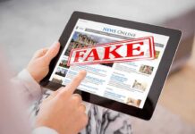 One Image: Four Numbers. A National Political Debate. Person holding a tablet displaying a news website with a 'FAKE' stamp