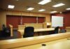 Police: New Jersey Woman Recorded Alleged Child Sexual Assault Interior view of an empty courtroom with wooden furniture and American flags