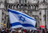 Judge Says Protest Clash Could Be Racial Discrimination Israeli flag at a crowded outdoor event.