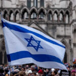 Israeli flag at a crowded outdoor event.