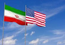 Trump’s Iran Strikes Left Nuclear Threat Unresolved Iran and United States flags waving on flagpoles