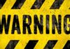 Doomsday Curve Nears: The World’s 2040 Warning warning sign with yellow and black hazard stripes