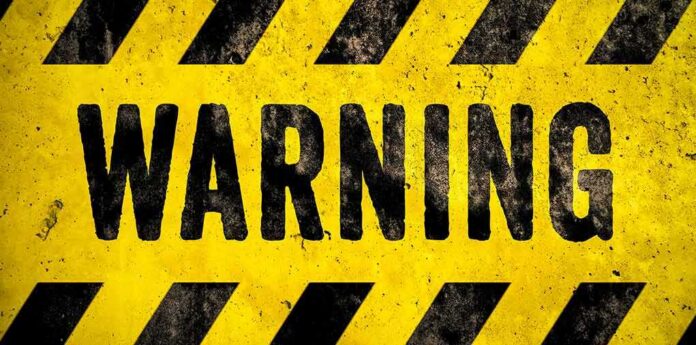 warning sign with yellow and black hazard stripes
