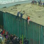 “Muslim Invasion” Claim Ignites Border Debate People climbing a tall beachside border fence