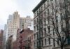 Street view of urban apartment buildings with fire escapes
