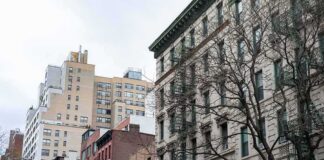 Street view of urban apartment buildings with fire escapes