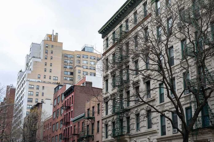 shutterstock_1649879845-1 Street view of urban apartment buildings with fire escapes