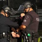 25 Arrested in San Francisco Theft Blitz Police officers handcuff a person during an arrest