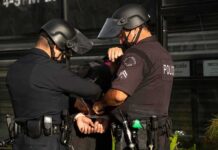 25 Arrested in San Francisco Theft Blitz Police officers handcuff a person during an arrest