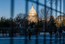 Crime Drops, But Violent Crime Holds U.S. Capitol behind security fencing and guards on a street