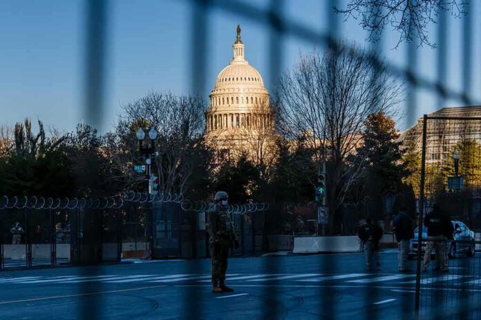 U.S. Capitol behind security fencing and guards on a street
