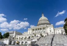 United States Capitol building under a bright blue sky