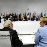 U.S. Tells Allies: Pick AI Side delegates seated around a large round conference table