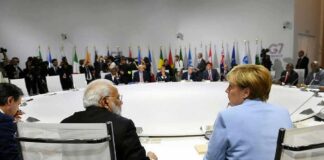 delegates seated around a large round conference table
