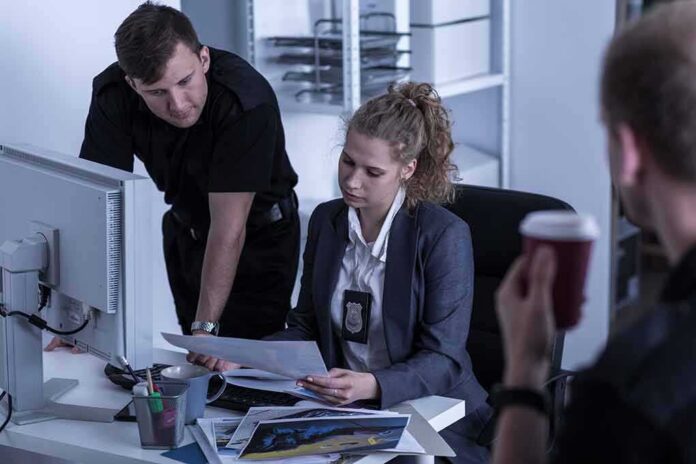 Police officers reviewing documents at a desk