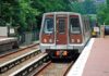Senator Nearly Hit by Passing Train at Rail-Safety Event Metro train arriving at a station surrounded by greenery