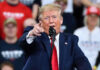 Endless Bombing? Trump Warns of More Iran Strikes Man in suit pointing, speaking at a rally.
