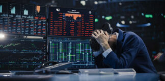 Trader stressed out by multiple declining stock charts.