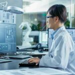 Scientists Reassess Extreme Climate Projections Engineer in lab coat working at a computer in a modern lab